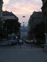 View down urban street near sunset