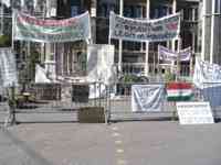 Protestors with signs in front of parliament building