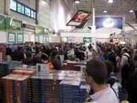 People shopping among stacks and stacks of games