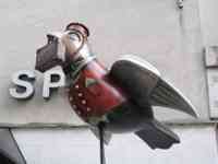 Sparrow sculpture decorated like a hotel bellhop