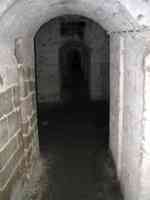 Dark underground hallway of prison cells