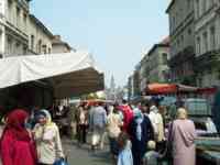 Several blocks lined on both sides with temporary market stalls and packed with people
