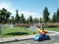 Kids in small cars in a Legoland park driving area