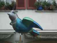 Sculpture of an elegant lady sparrow with eyelashes and necklace