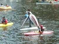Man wearing red-and-white striped wings on raft