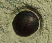Cannonball embedded in a wall