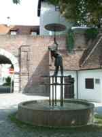 Fountain with statue of a person holding an umbrella