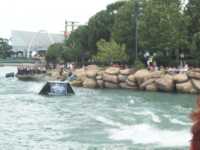 Jet skiers racing off a ramp